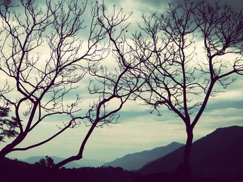 Scenic view of mountains against cloudy sky