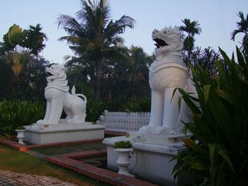 Statue of trees against sky