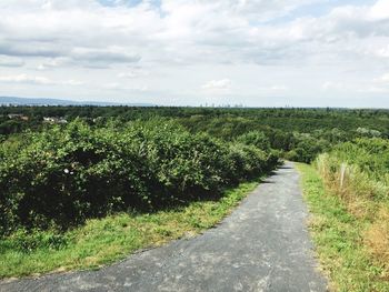 Scenic view of field against cloudy sky