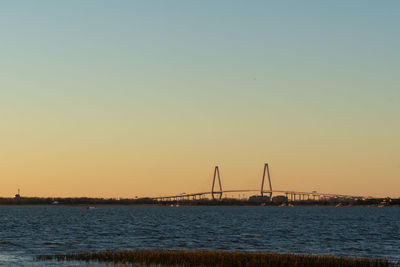 Arthur ravenel jr. bridge overlooks charleston during a dusky sunset.