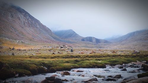 Scenic view of landscape and mountains against sky