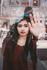 Portrait of young woman standing outdoors