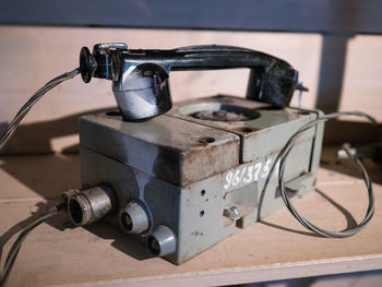 Close-up of vintage machinery with telephone receiver