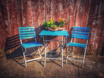 Empty chairs and tables against wall