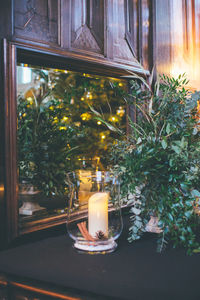 Illuminated tea light candles in building