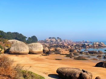 Scenic view of rocks against clear blue sky