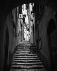 Low angle view of narrow alley amidst buildings