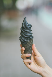 Cropped hand holding ice cream cone