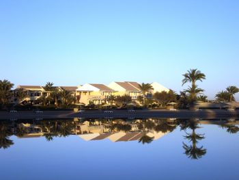 Scenic view of lake against clear blue sky