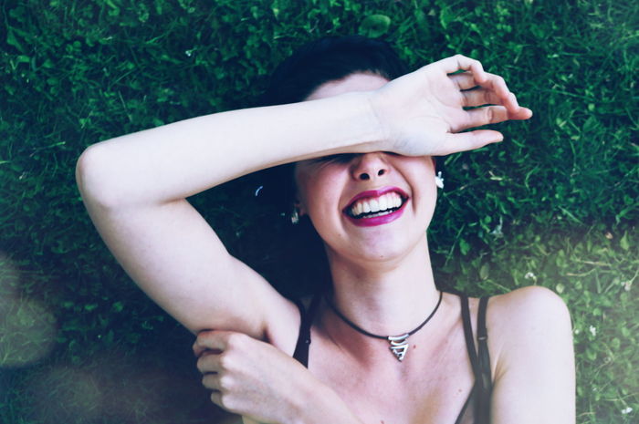 PORTRAIT OF YOUNG WOMAN IN GRASS