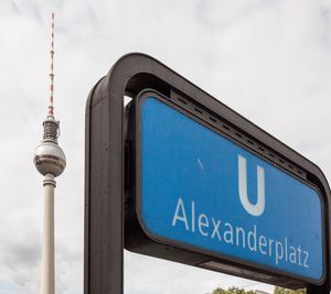 Low angle view of road sign against sky