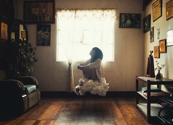 Woman floating on cloud in room