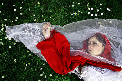 Young woman lying down on grass