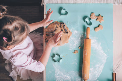 Directly above shot of girl making cookie at home