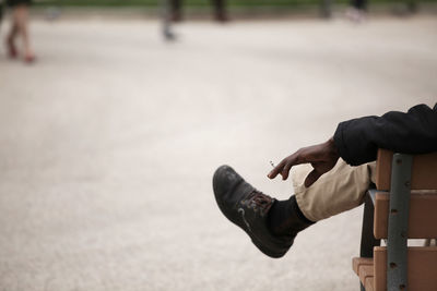Low section of man skateboarding on road