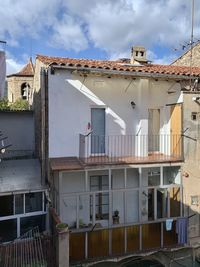 Exterior of houses in town against sky