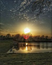 Scenic view of river at sunset