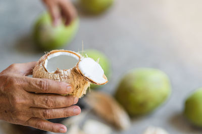 Close-up of hand holding coconut