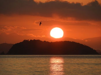 Scenic view of sea against orange sky