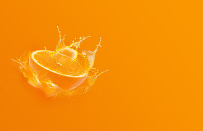 Close-up of orange over white background