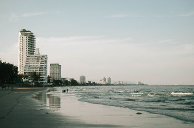 Buildings on beach against sky in city