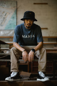 Portrait of man sitting on table