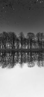 Scenic view of lake against sky during winter