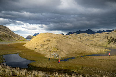 Scenic view of land and mountains against sky