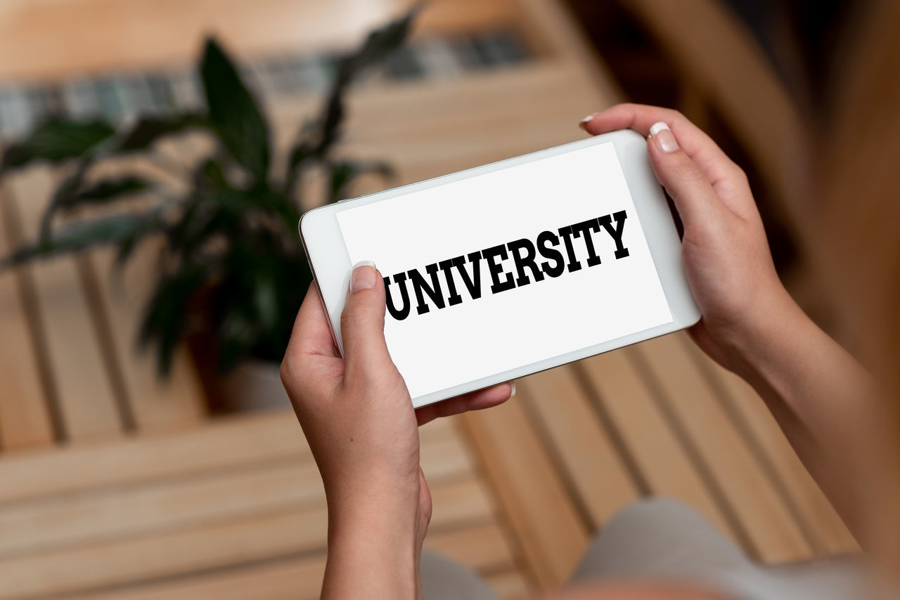 LOW SECTION OF WOMAN HOLDING TEXT ON WHITE