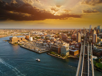 High angle view of buildings in city during sunset