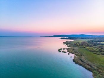 Scenic view of sea against clear sky during sunset