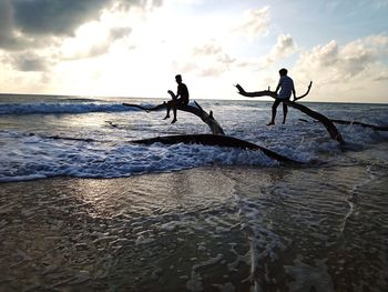 People on beach against sky