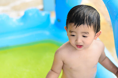 Portrait of shirtless boy in swimming pool