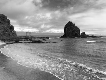 View of beach against cloudy sky