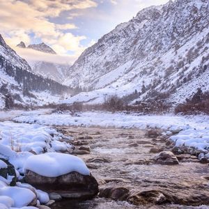 Scenic view of snow covered mountains against sky