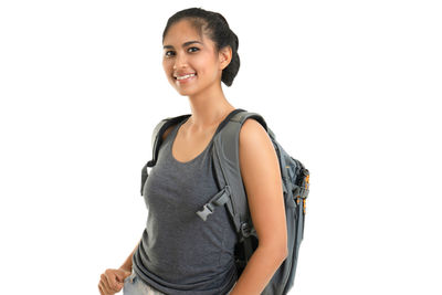 Portrait of a smiling young woman against white background