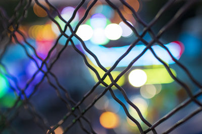 Close-up of illuminated lights on fence