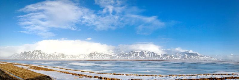 Panoramic view of sea against blue sky