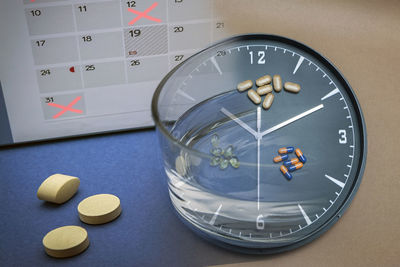 High angle view of clock on table