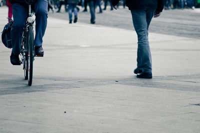 Low section of people walking on street