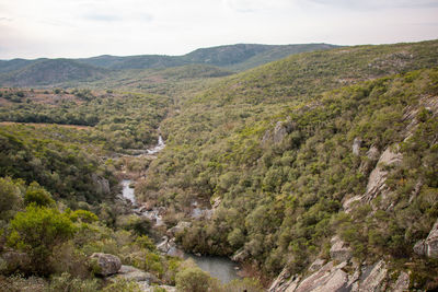 Scenic view of river amidst mountains against sky