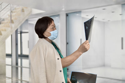 Nurse examining x-ray at hospital