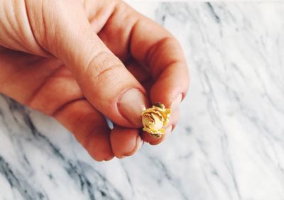 Close-up of hand holding flower