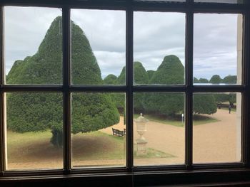 Scenic view of mountains seen through glass window