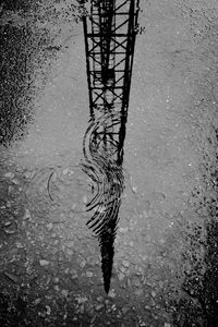 Reflection of tower in puddle