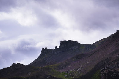 Scenic view of mountains against cloudy sky