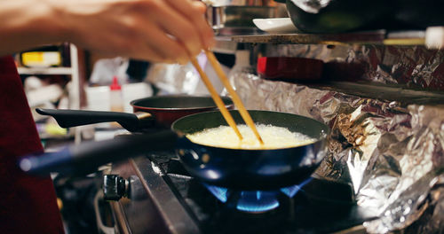 Cropped hand of man preparing food