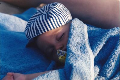 Cute baby boy sleeping on bed