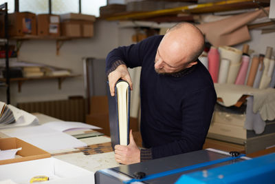 Man holding book at store