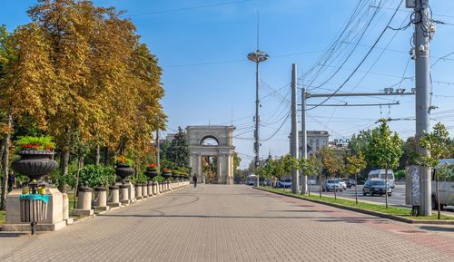 Street amidst trees and plants against sky